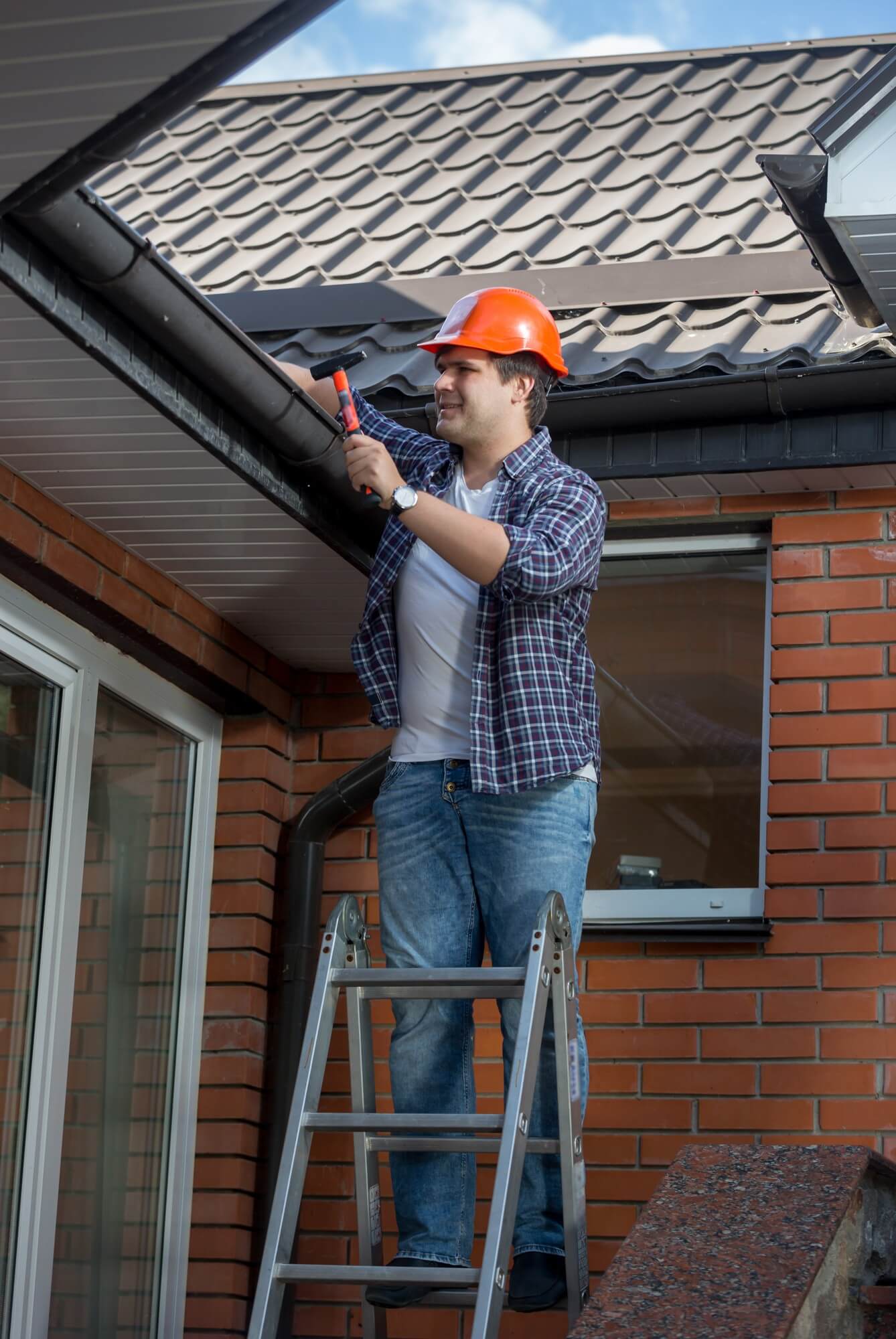 Roofer applying single ply membrane on a commercial flat roof