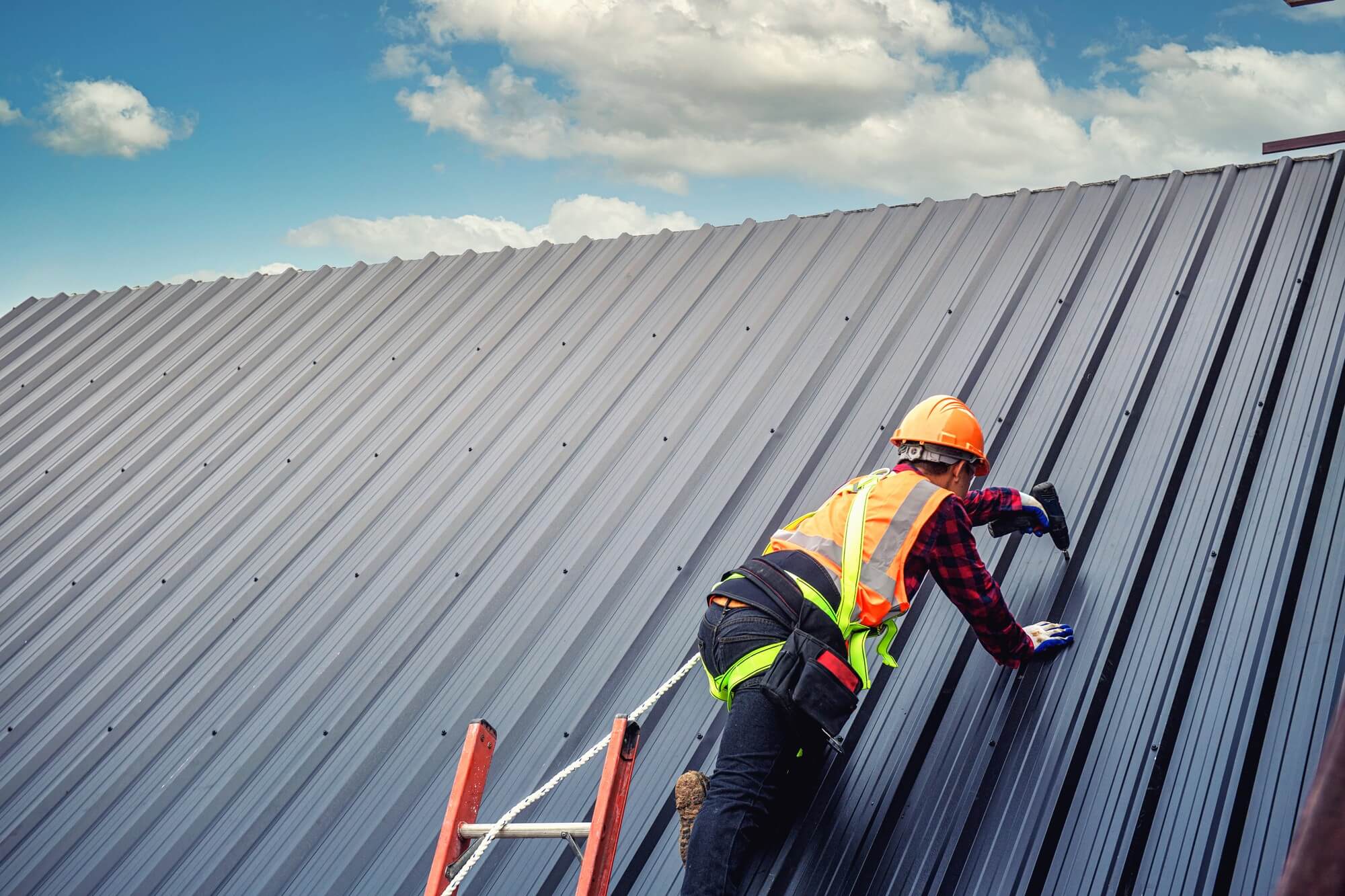 Roofing contractor inspecting a commercial flat roof membrane